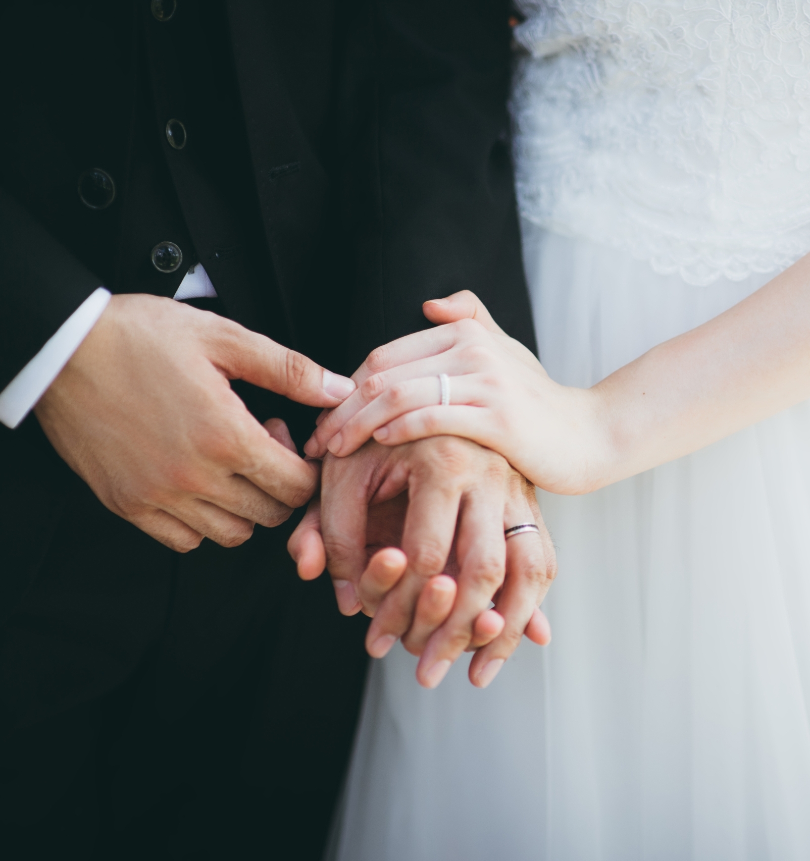 A bride and groom hold hands