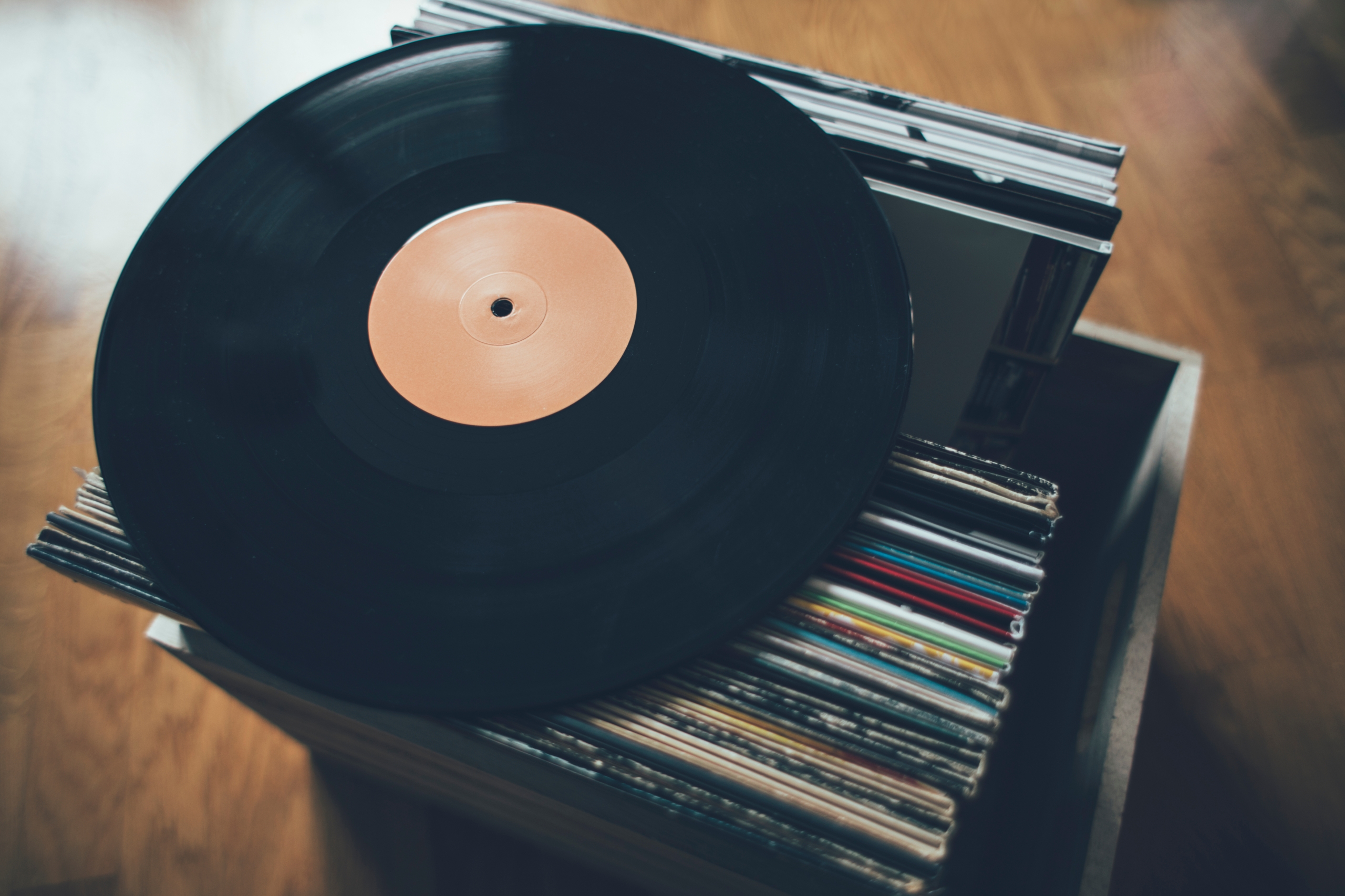 A vinyl record on top of a stack of records