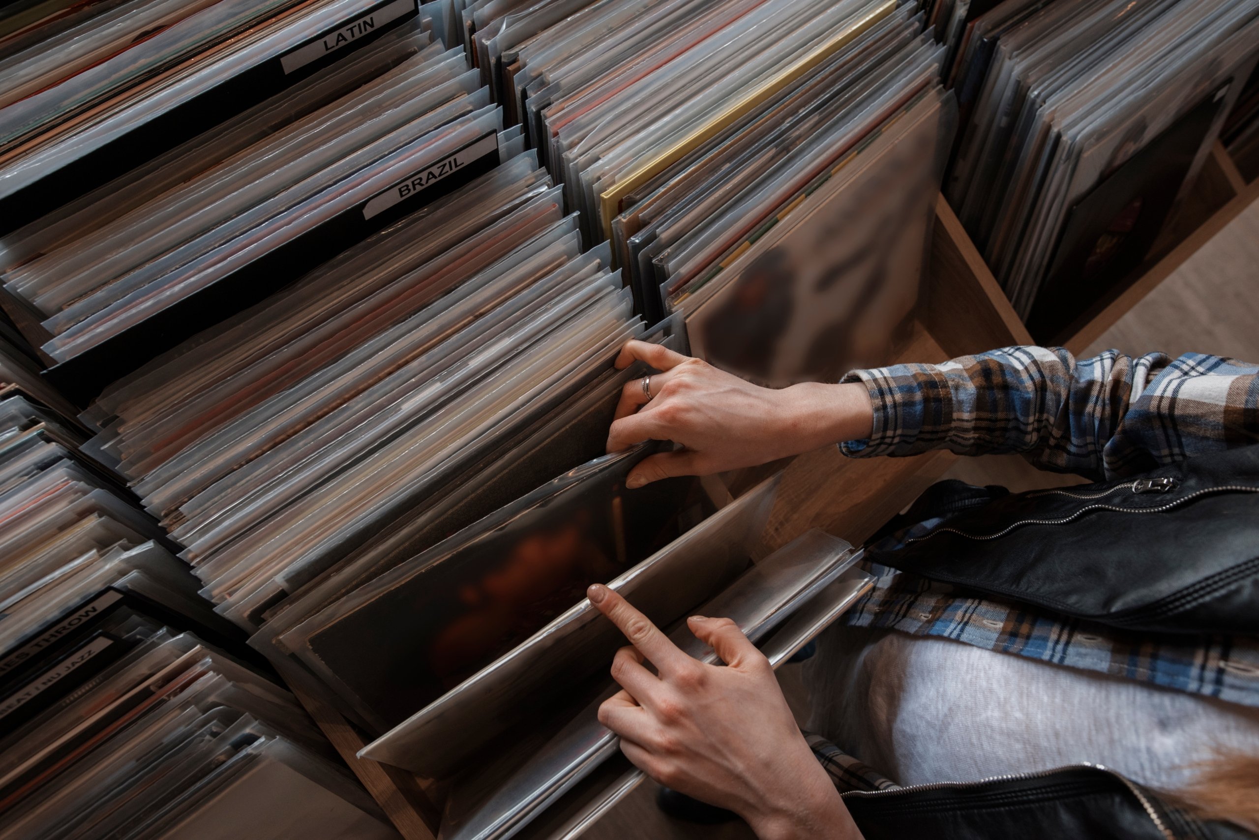 A person flipping through a bin of records