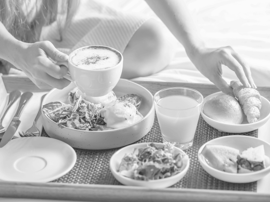 A woman grabs a cappuccino and croissant from a breakfast tray at Asher Adams Hotel, Salt Lake City