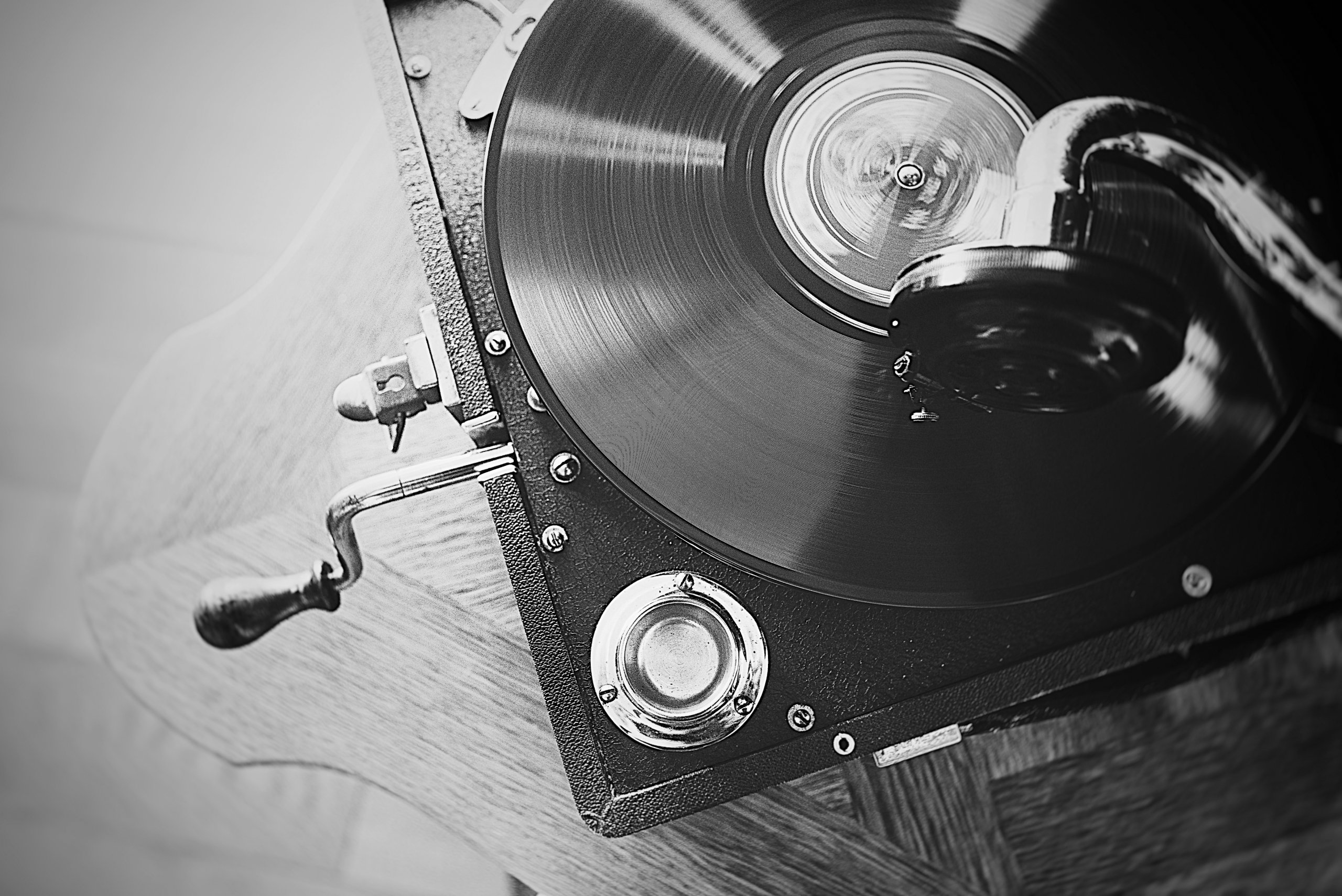 A black and white classic record player spins a record