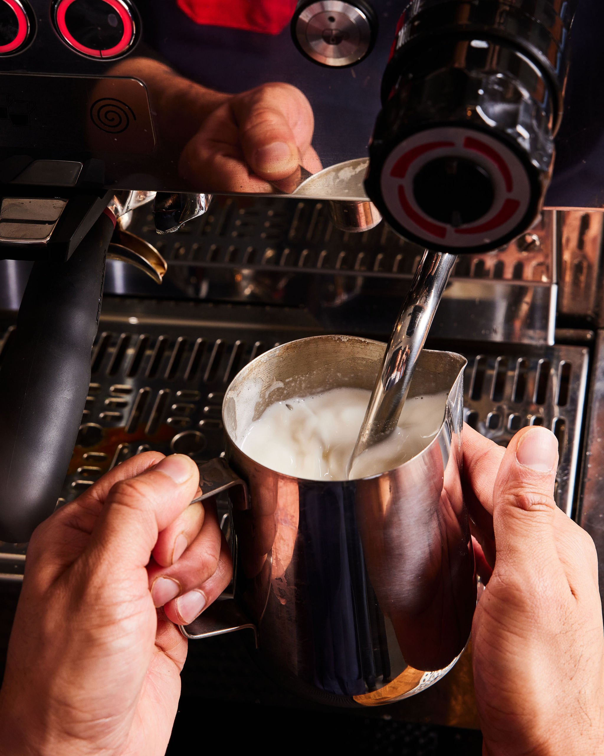 A barista steams milk using an espresso machine at Counterpart at Asher Adams Hotel, Salt Lake City