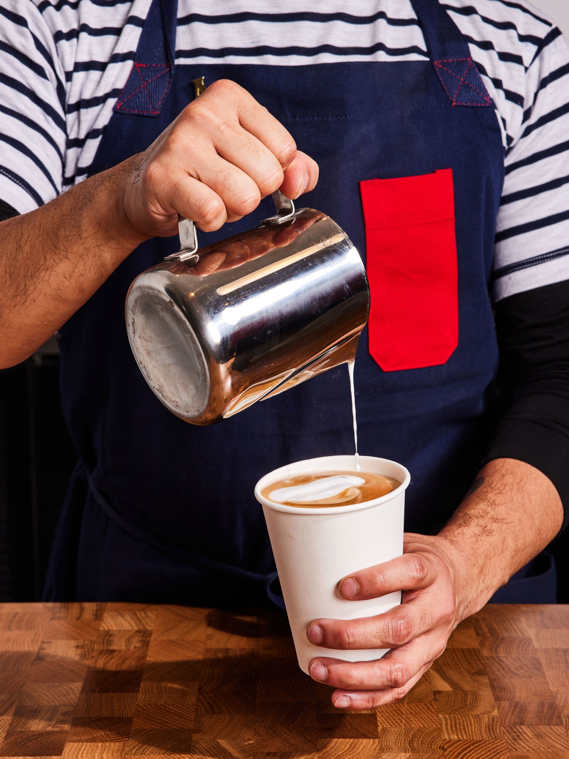 A barista pours steamed milk into an espresso drink at Counterpart at Asher Adams Hotel, Salt Lake City