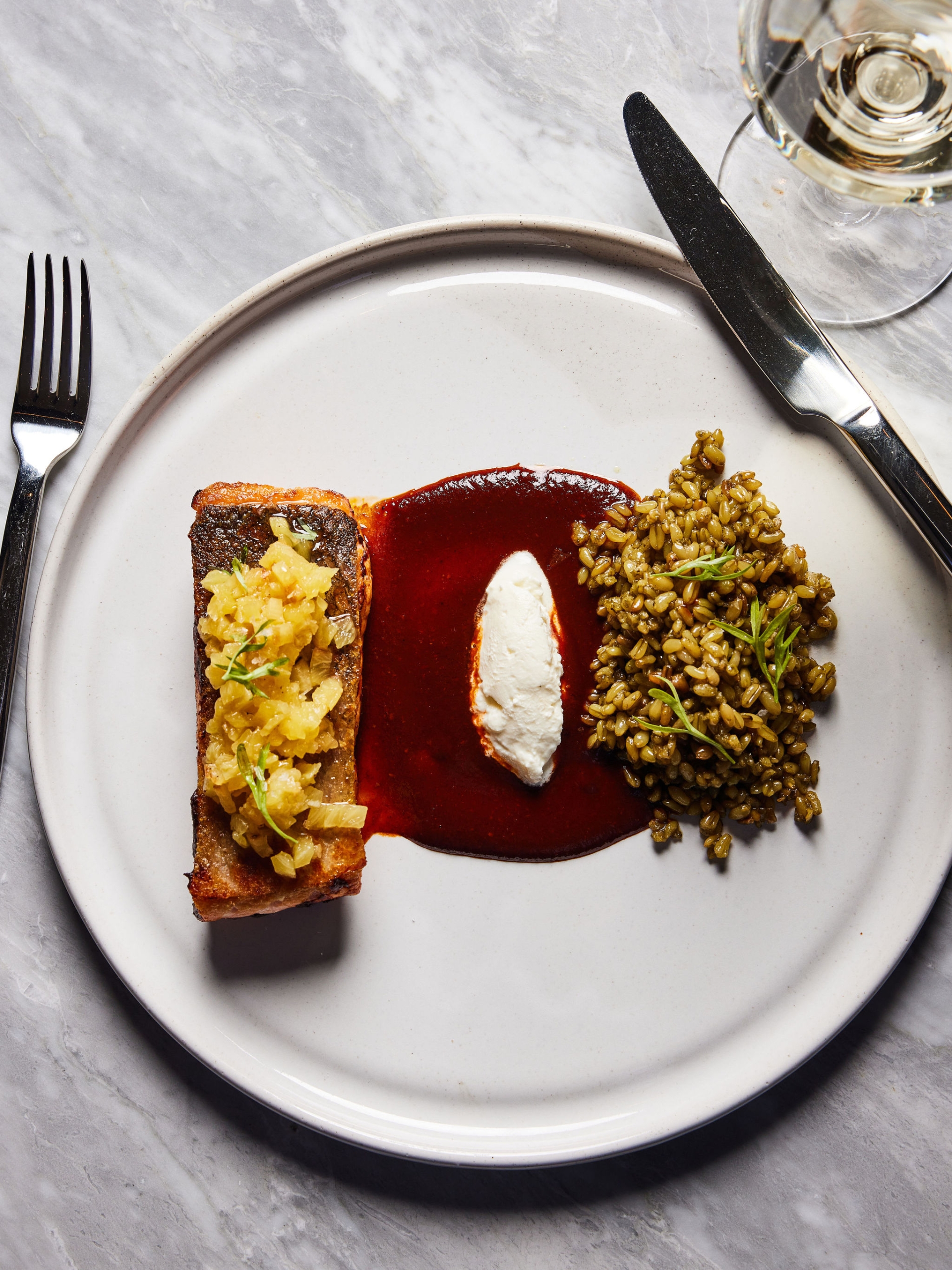 A salmon dish with sauce and farro served at Rouser, restaurant at Asher Adams Hotel, Salt Lake City