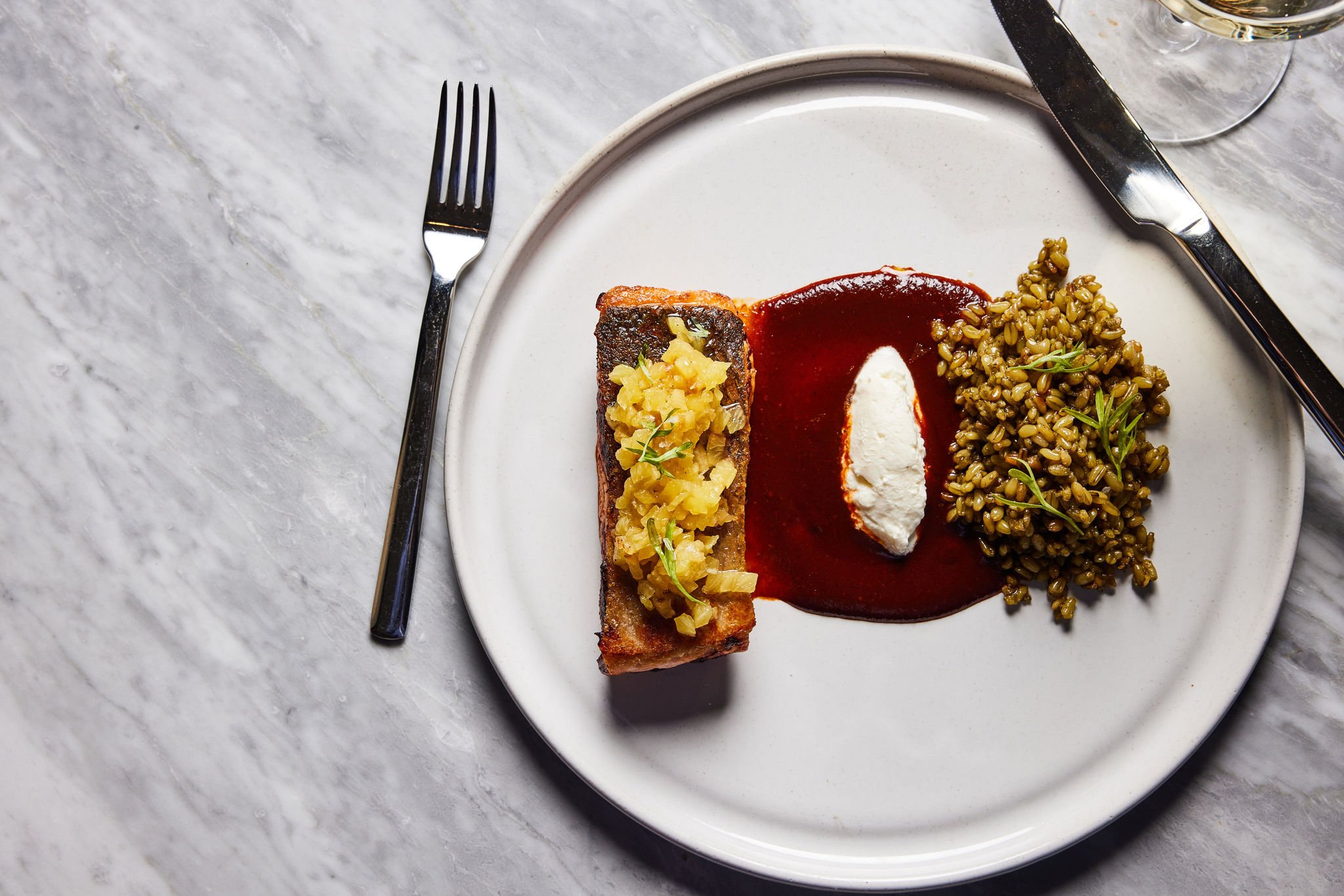 A salmon dish with sauce and farro served at Rouser, restaurant at Asher Adams Hotel, Salt Lake City