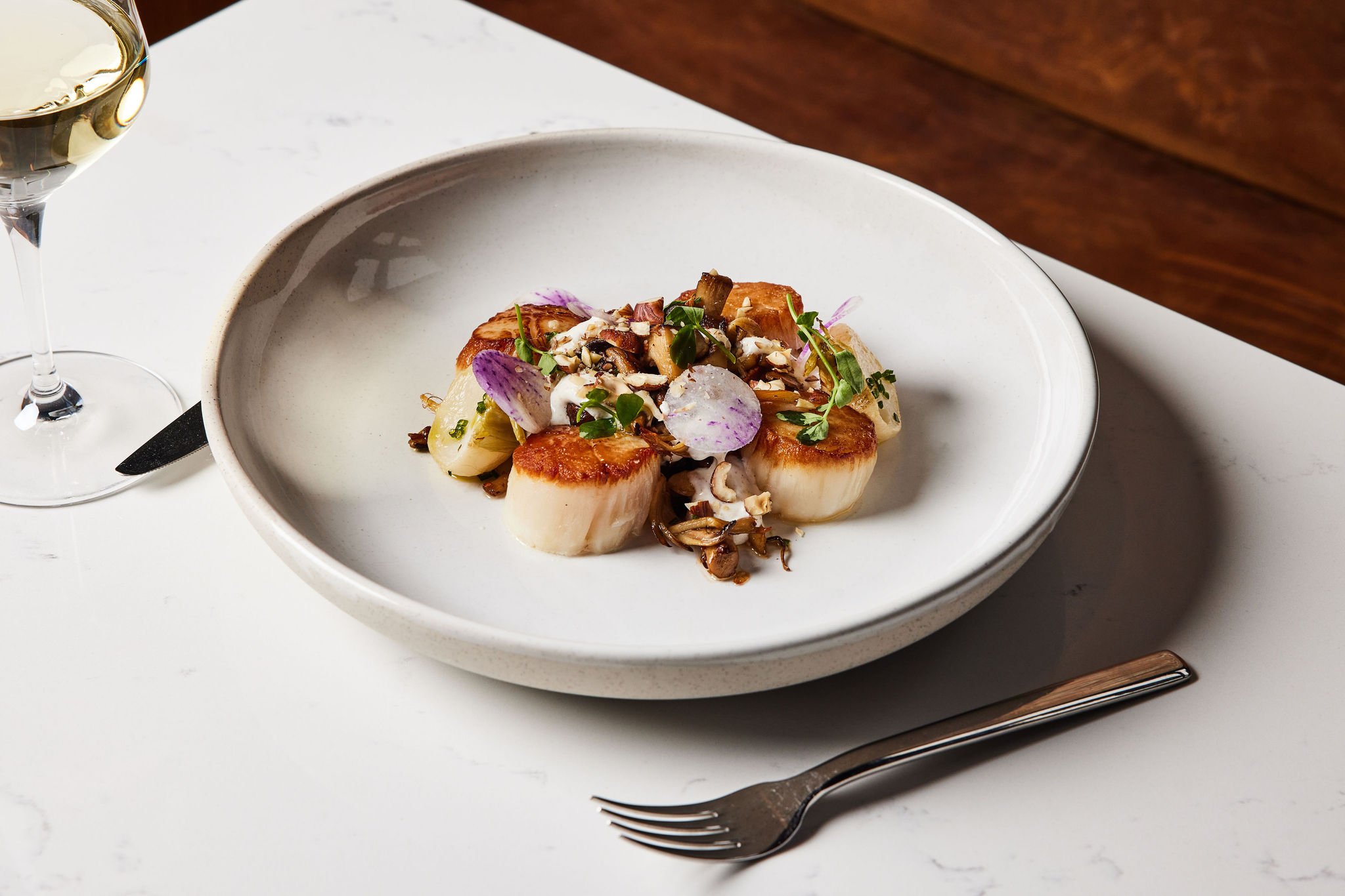 Scallops with delicate garnishes served at Rouser, restaurant at Asher Adams Hotel, Salt Lake City