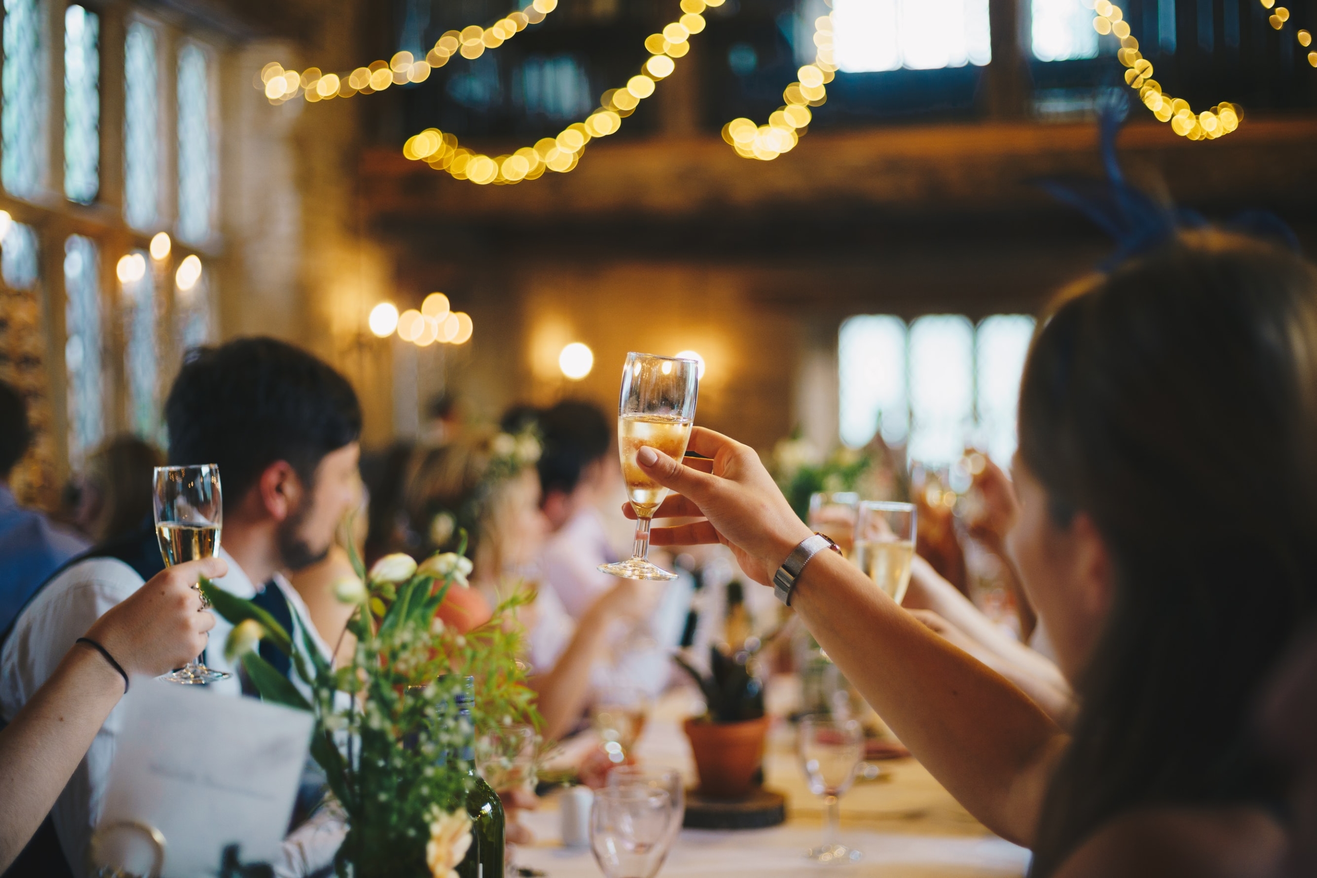 Event guests raise champagne flutes to cheers at Asher Adams Hotel, Salt Lake City