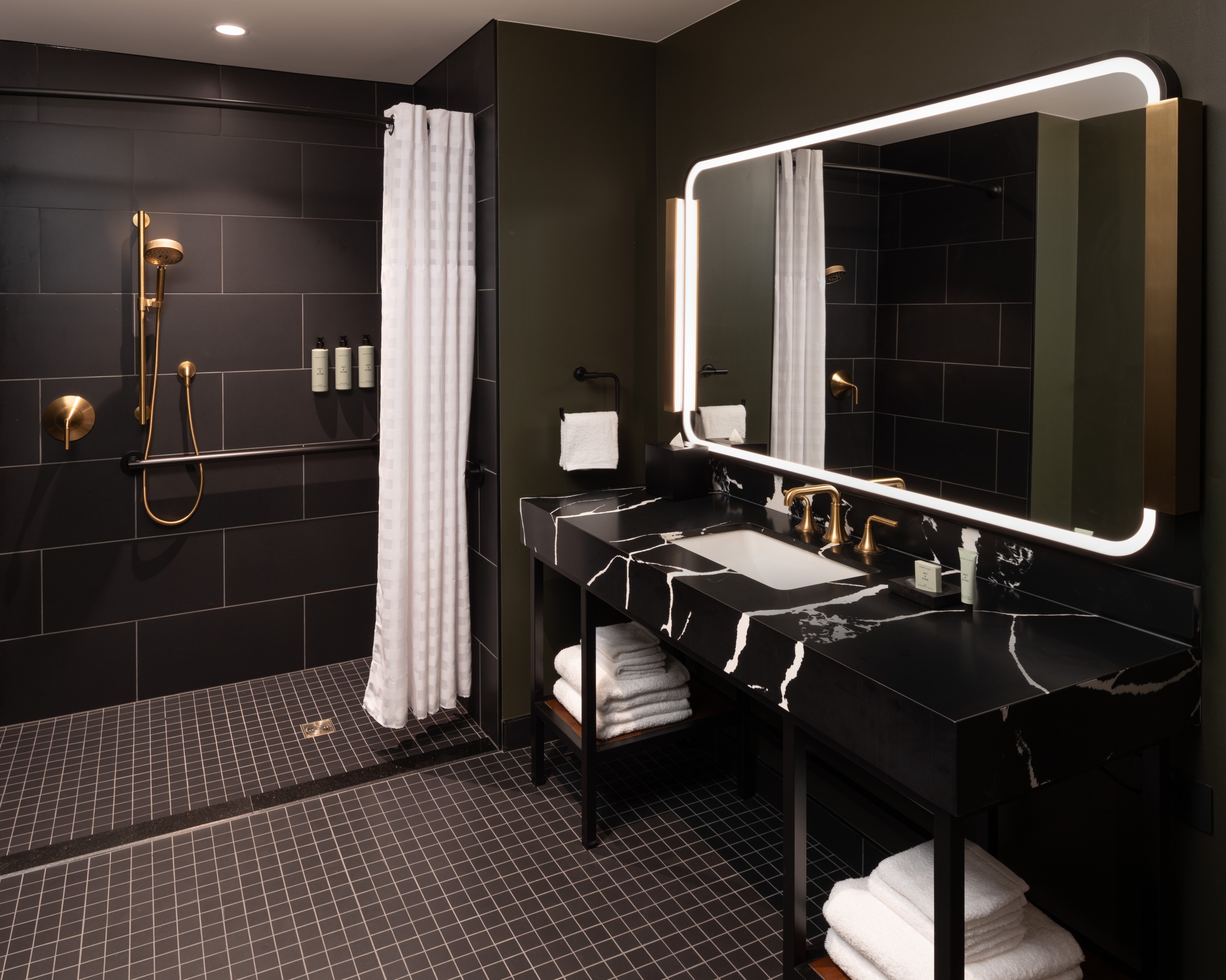 An ADA roll-in shower and roll up sink in a guest room at Asher Adams Hotel, Salt Lake City