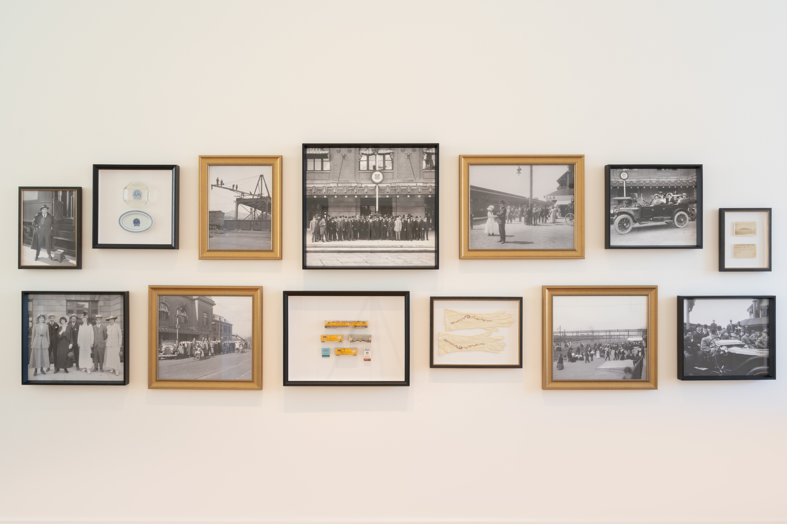 Framed mementos and old photos displayed on a wall at Asher Adams Hotel, Salt Lake City