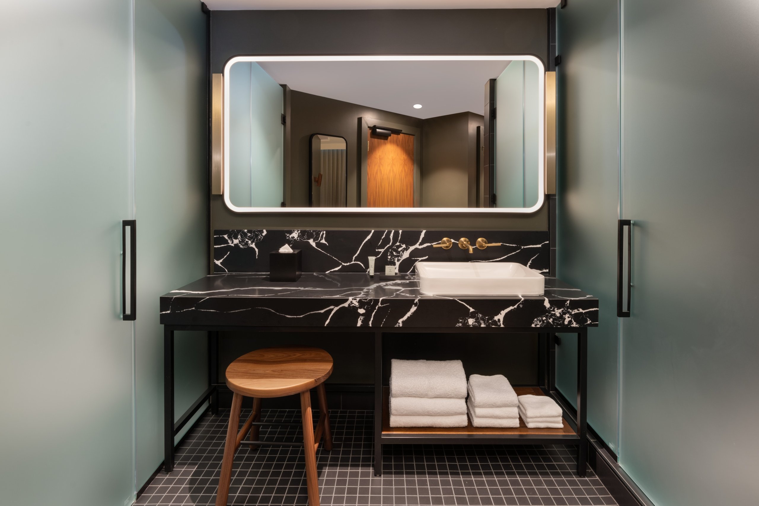 A washroom sink with clean towels in a guest room at Asher Adams Hotel, Salt Lake City