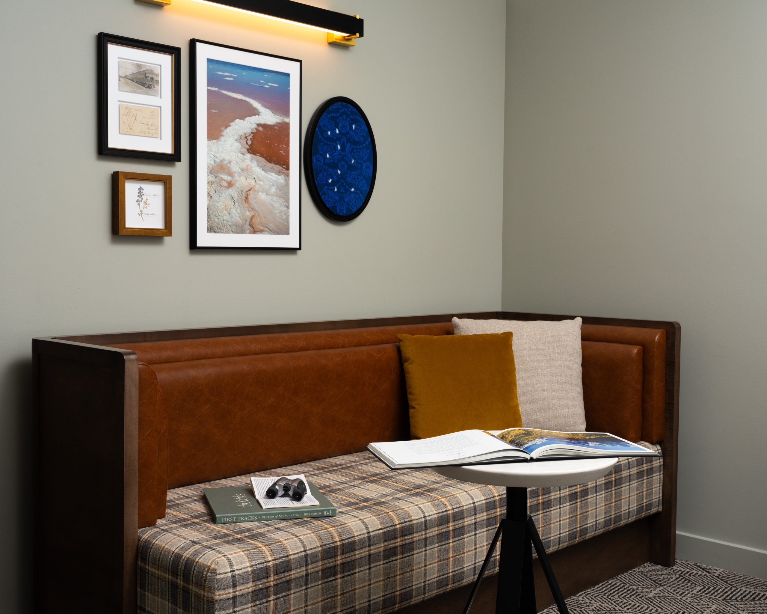 A seating area with books and art work in a room at Asher Adams Hotel, Salt Lake City