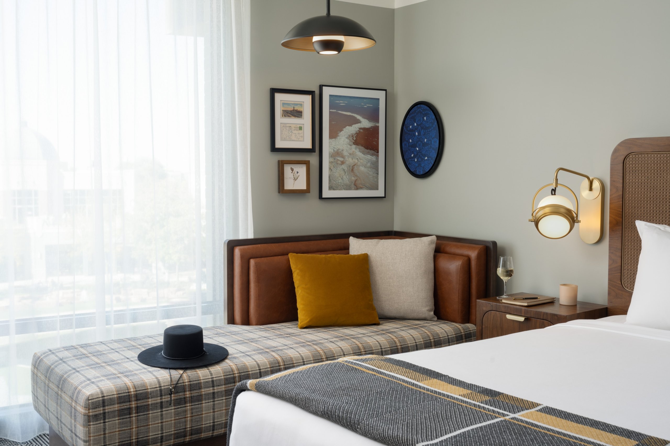 A black hat on a chaise in a suite at Asher Adams Hotel in Salt Lake City