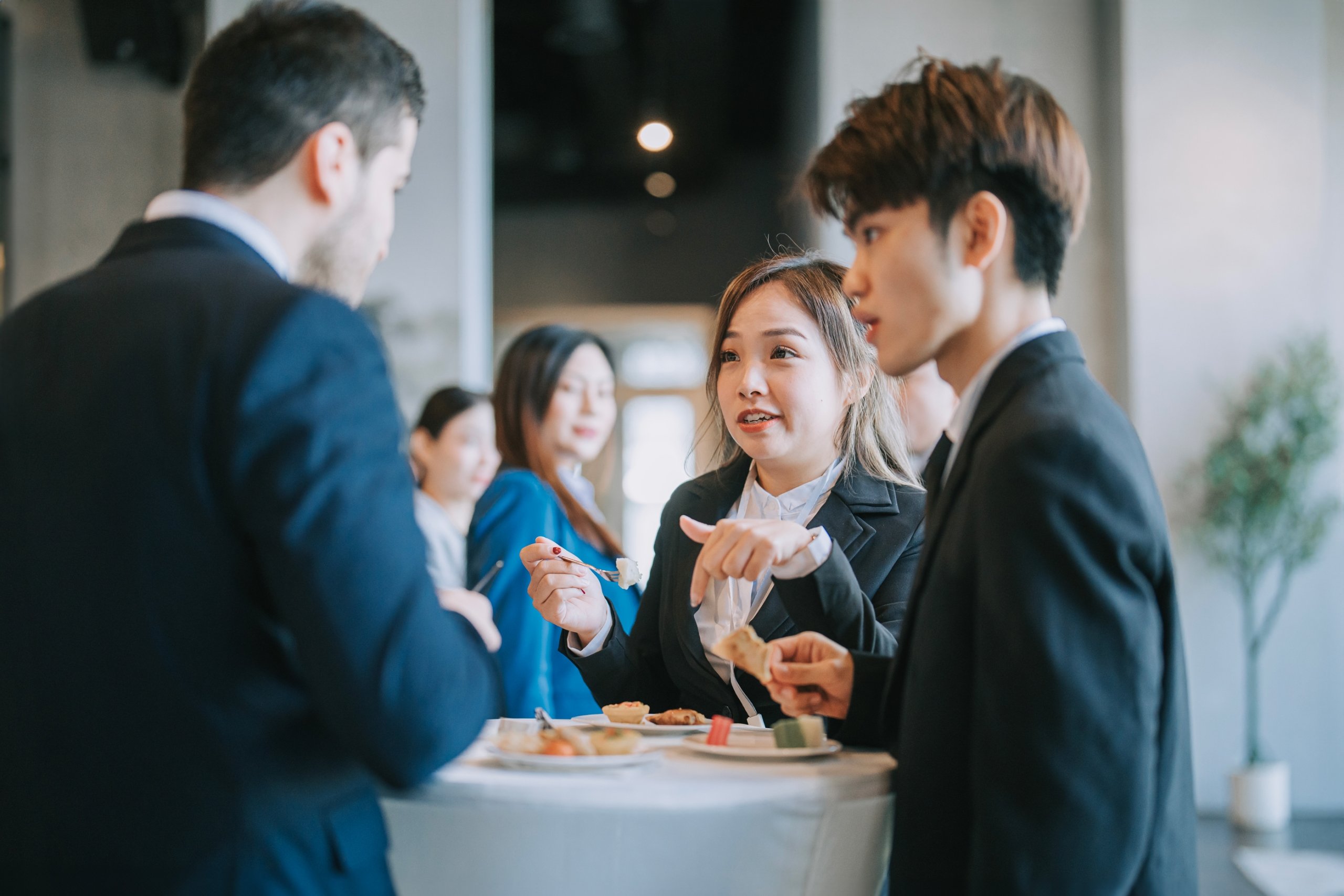 Group of event go-ers in suits at a catered social event