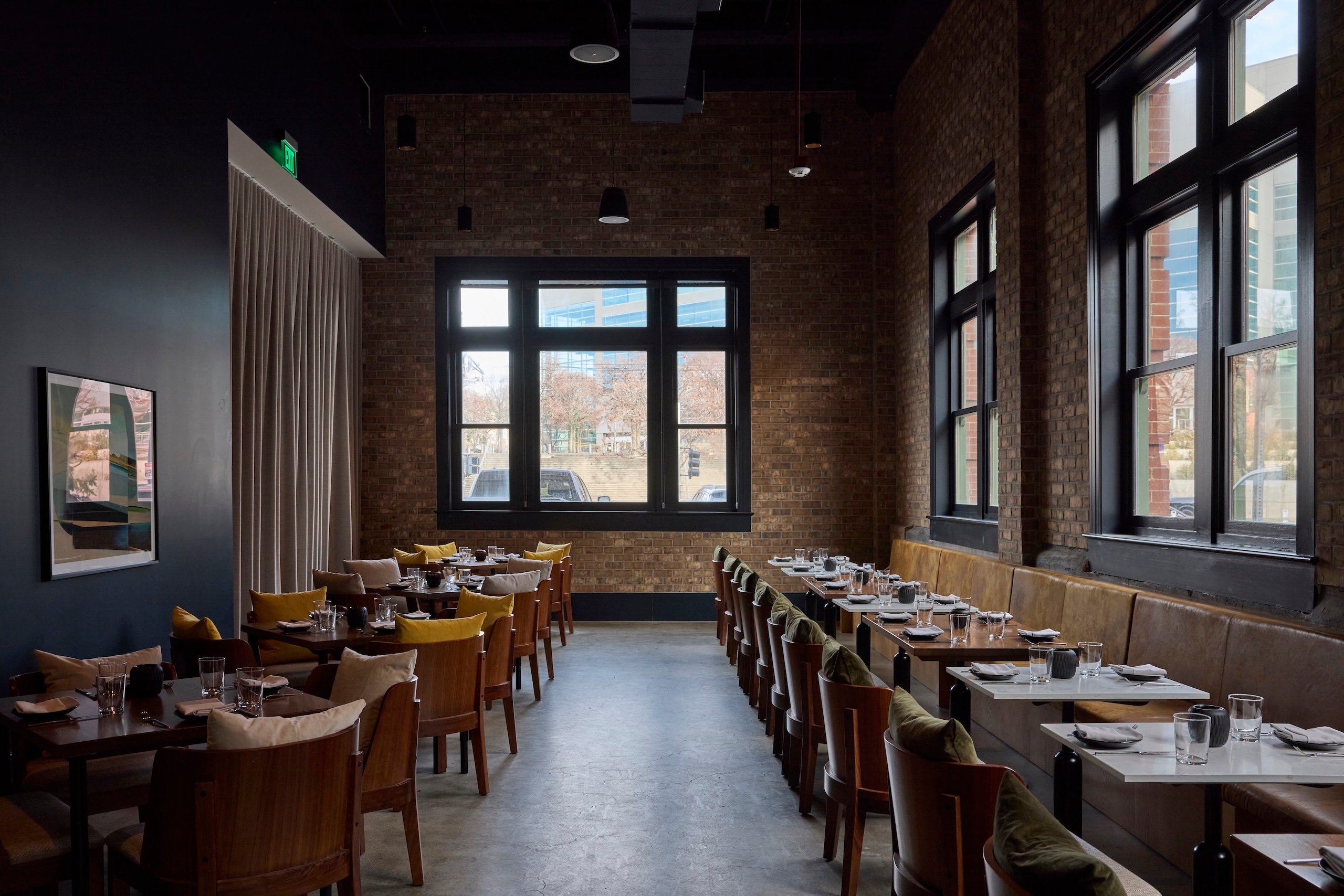 Restaurant tables at comfortable booth seating set for a dinner seating at Asher Adams Hotel, Salt Lake City