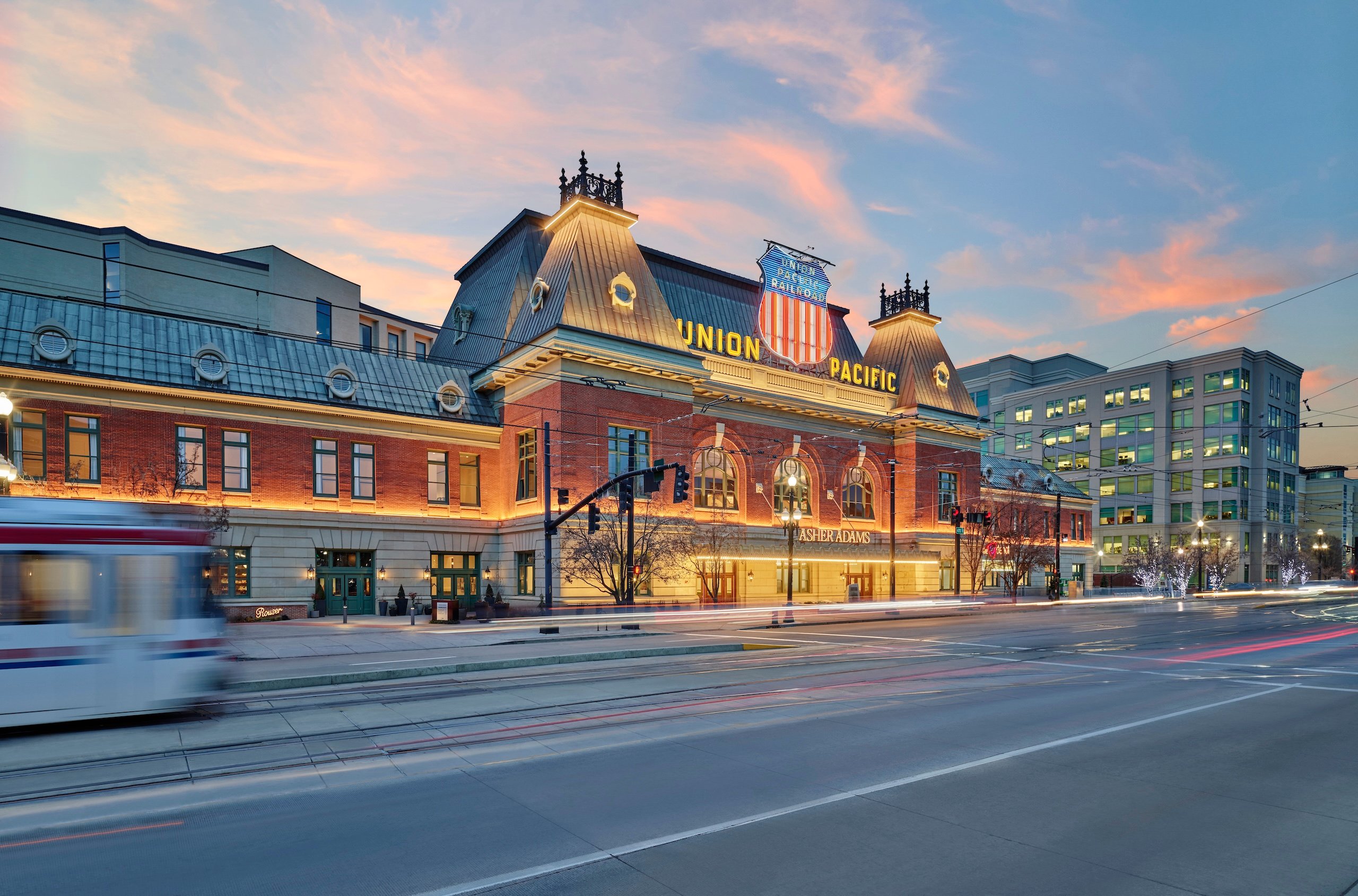 A street car goes by in a blur at sunset outside of Asher Adams Hotel, Salt Lake City.