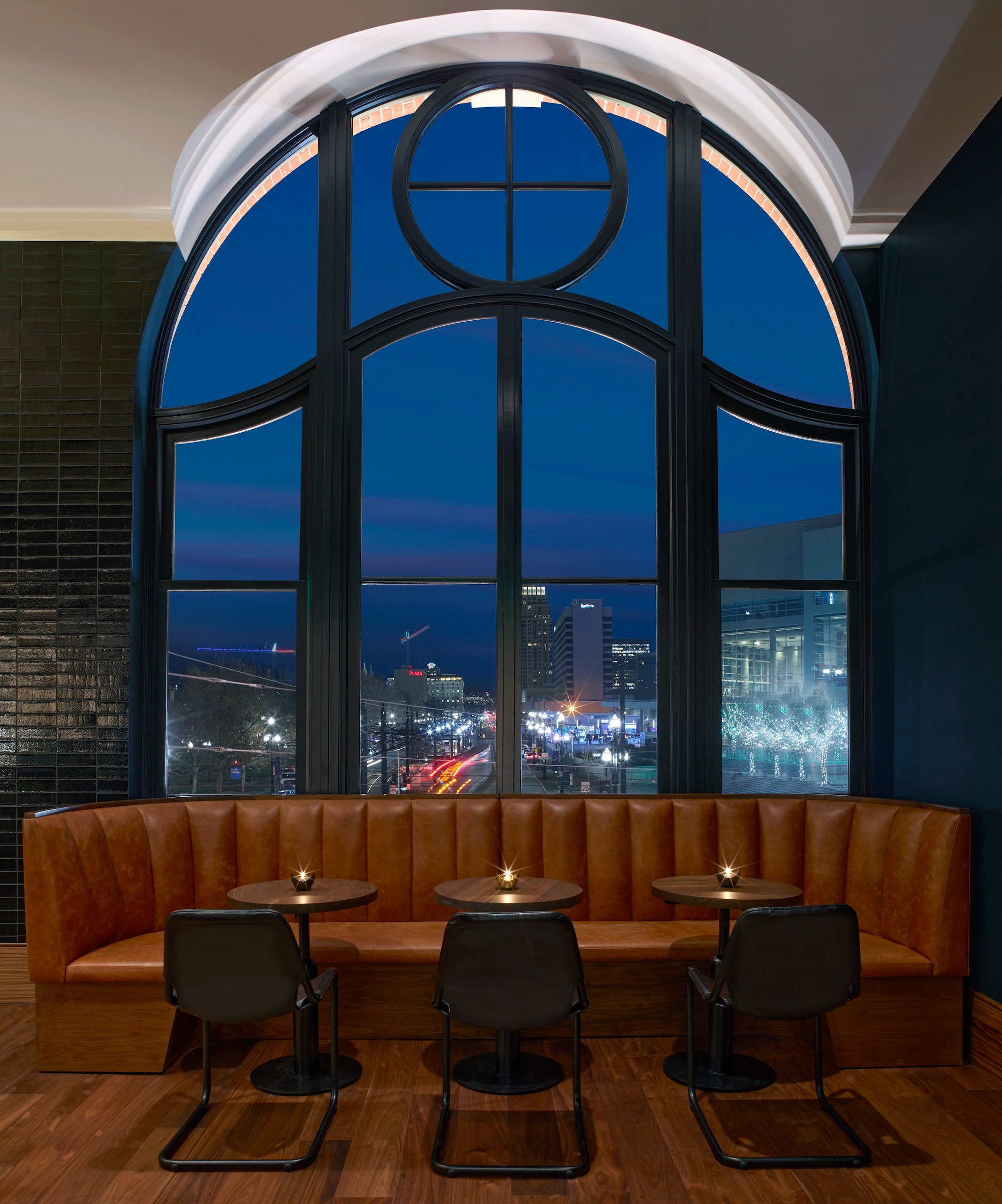 A booth inside No. 119 with views of downtown Salt Lake City lit up at night