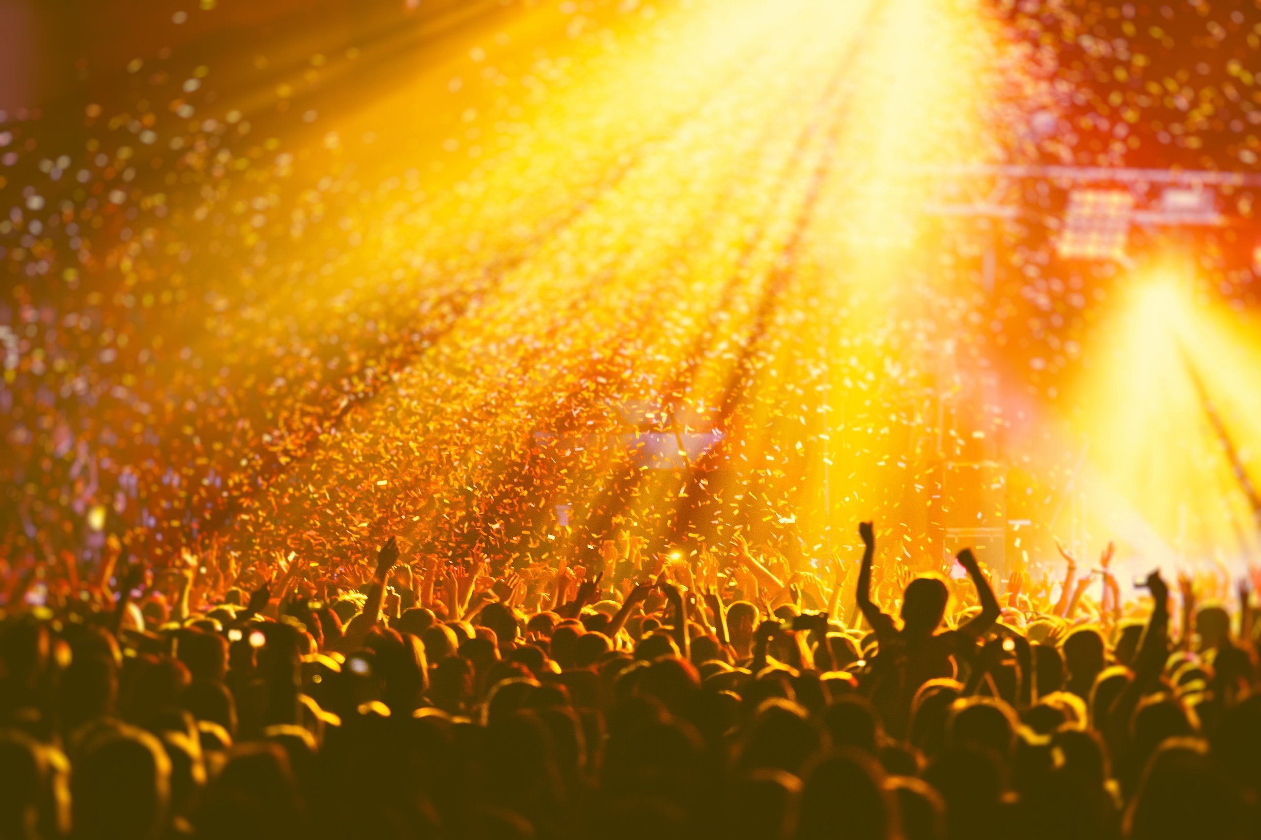 Confetti falling from the ceiling at a crowded live music event