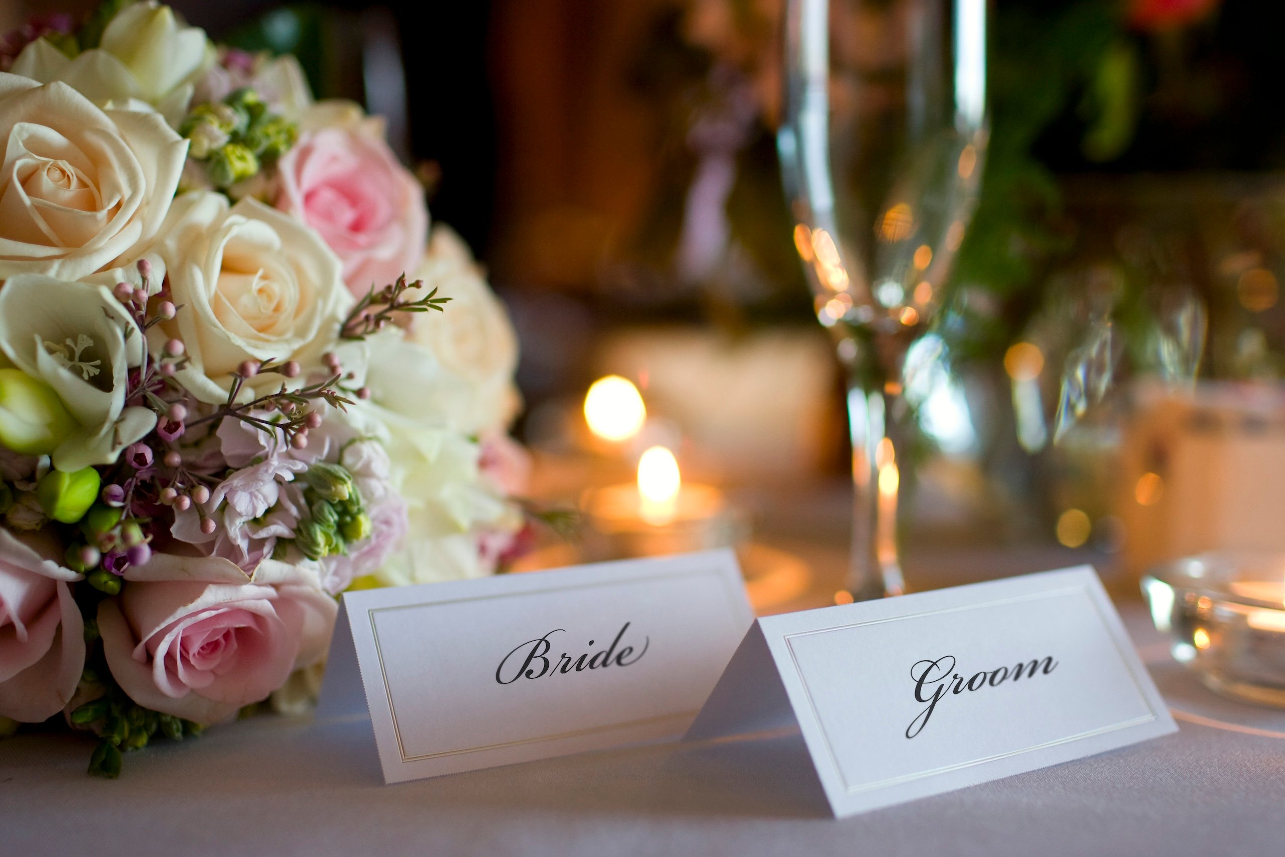 Bride and Groom Place Cards with Bouquet at Wedding Reception