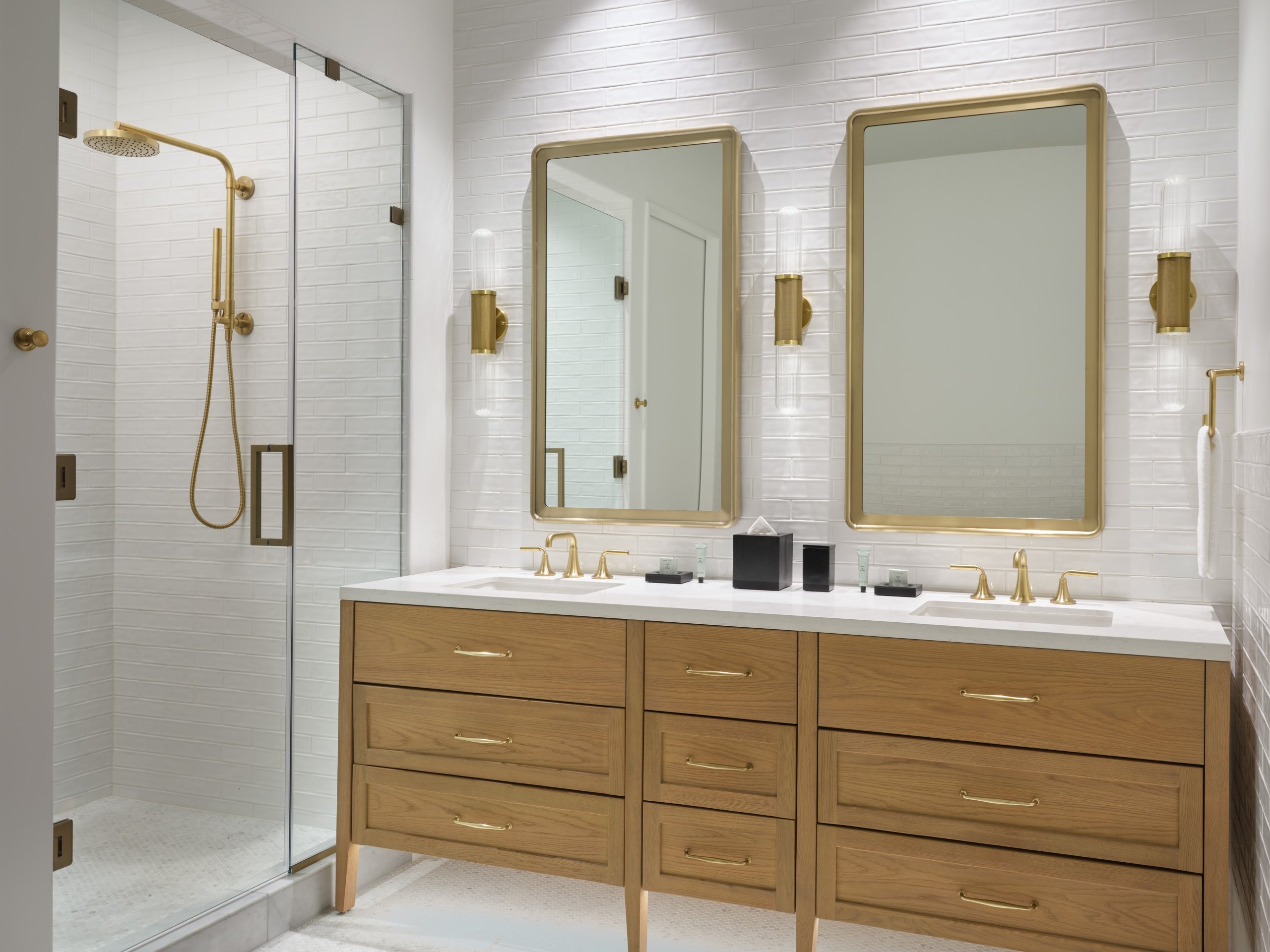 A bathroom with two-person vanity and glass rain shower in a suite at Asher Adams Hotel, Salt Lake City