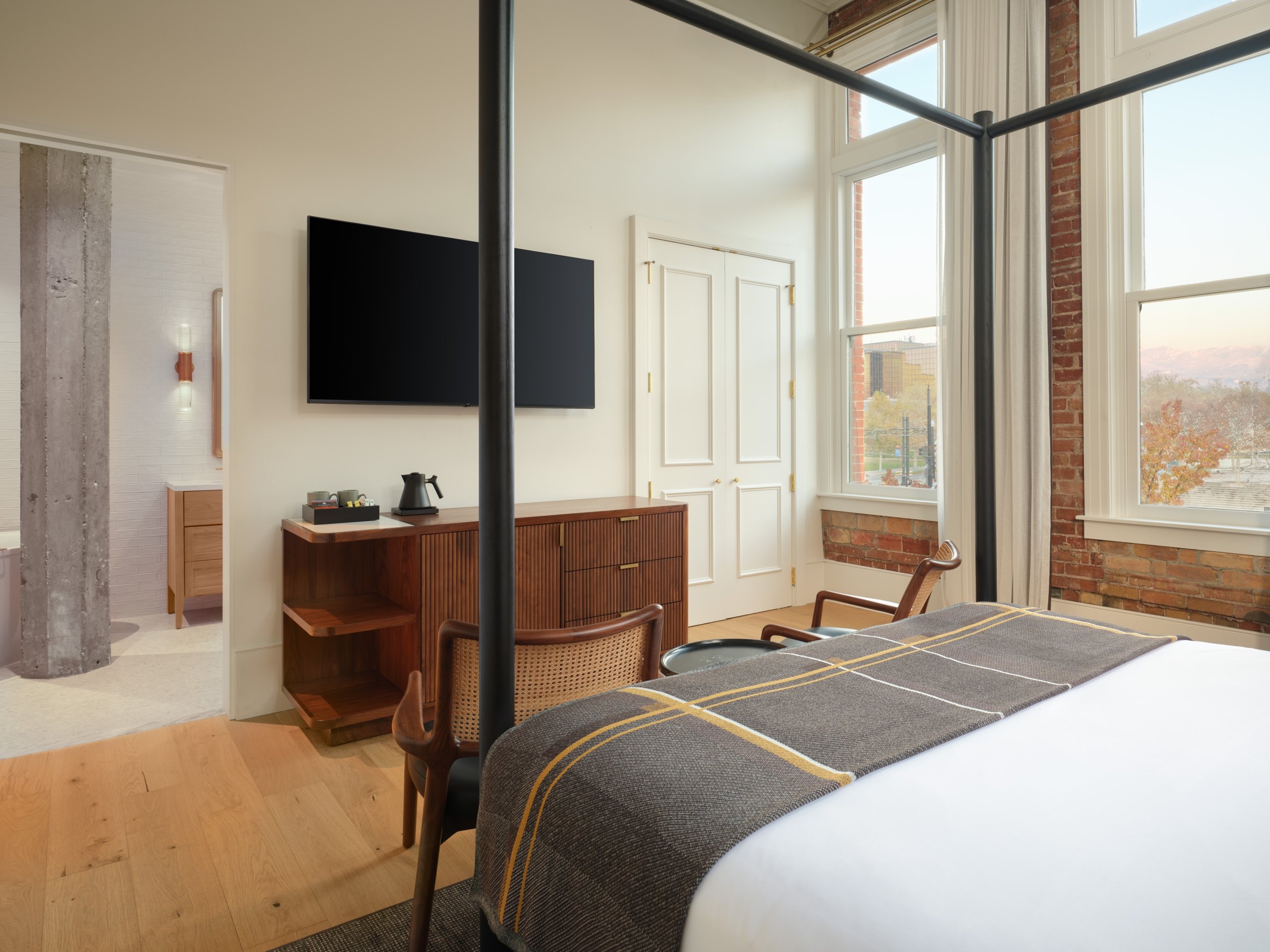 The bed, tv, and bathroom in the Historic Asher suite at Asher Adams Hotel, Salt Lake City