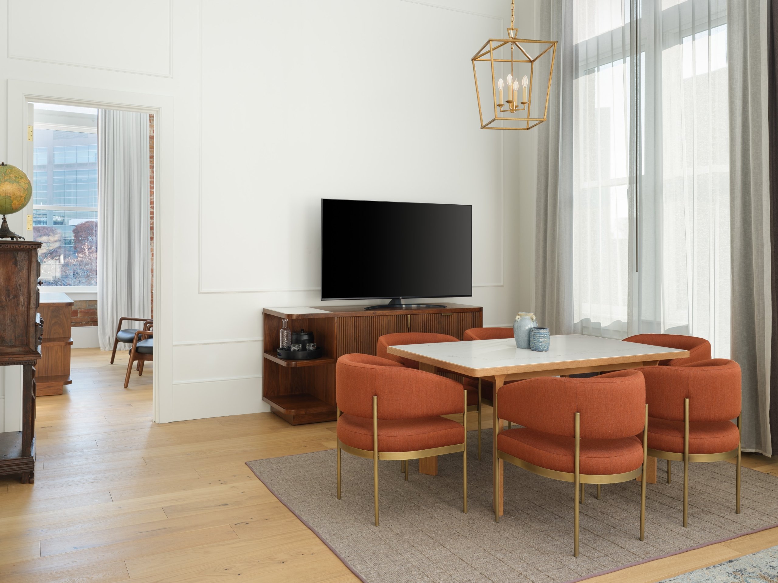 A living/dining area with tv in a suite at Asher Adams Hotel, Salt Lake City