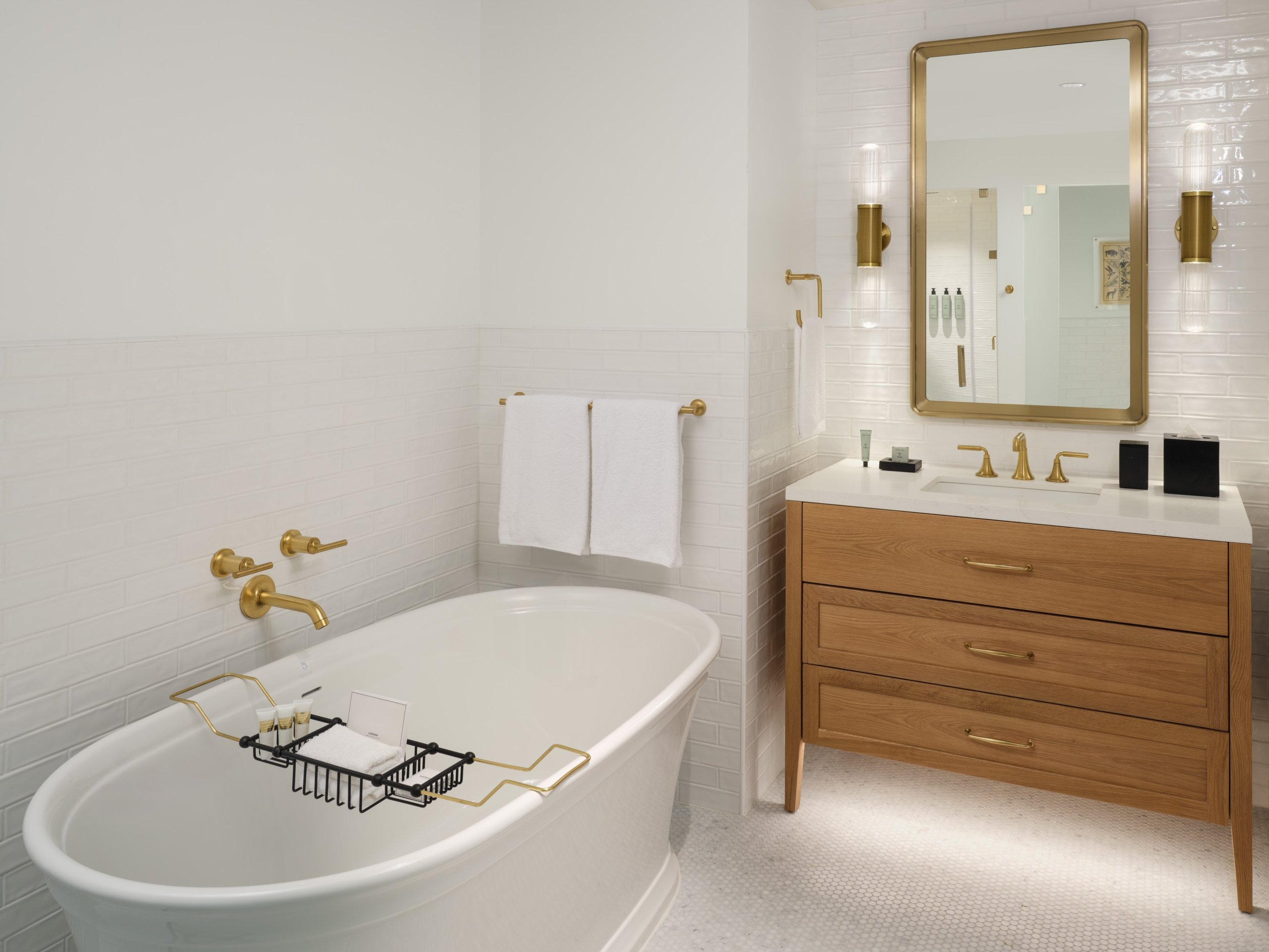 A bathroom vanity and large soaking tub in a suite at Asher Adams Hotel, Salt Lake City