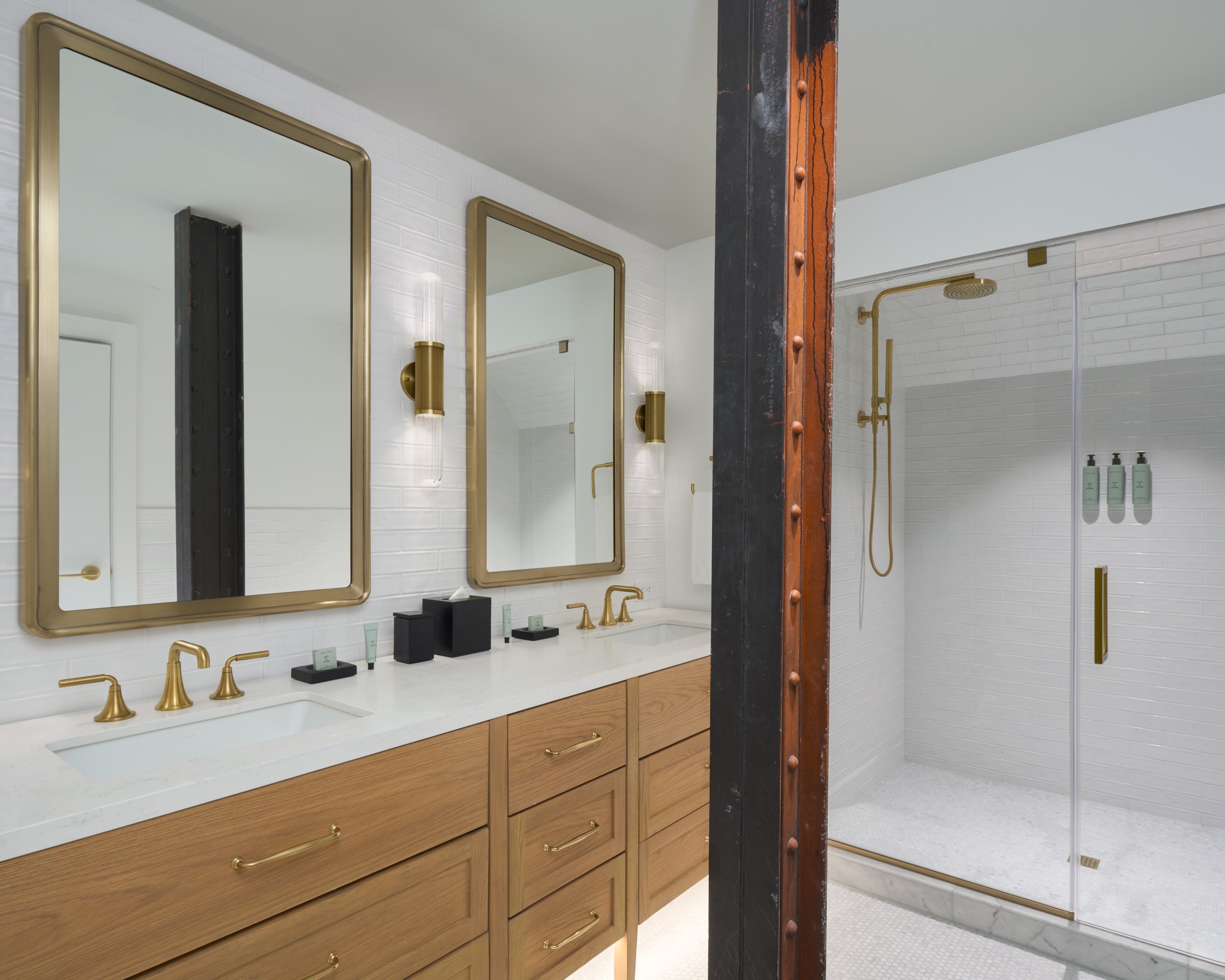 A bathroom with two-person vanity and glass rain shower at Asher Adams Hotel