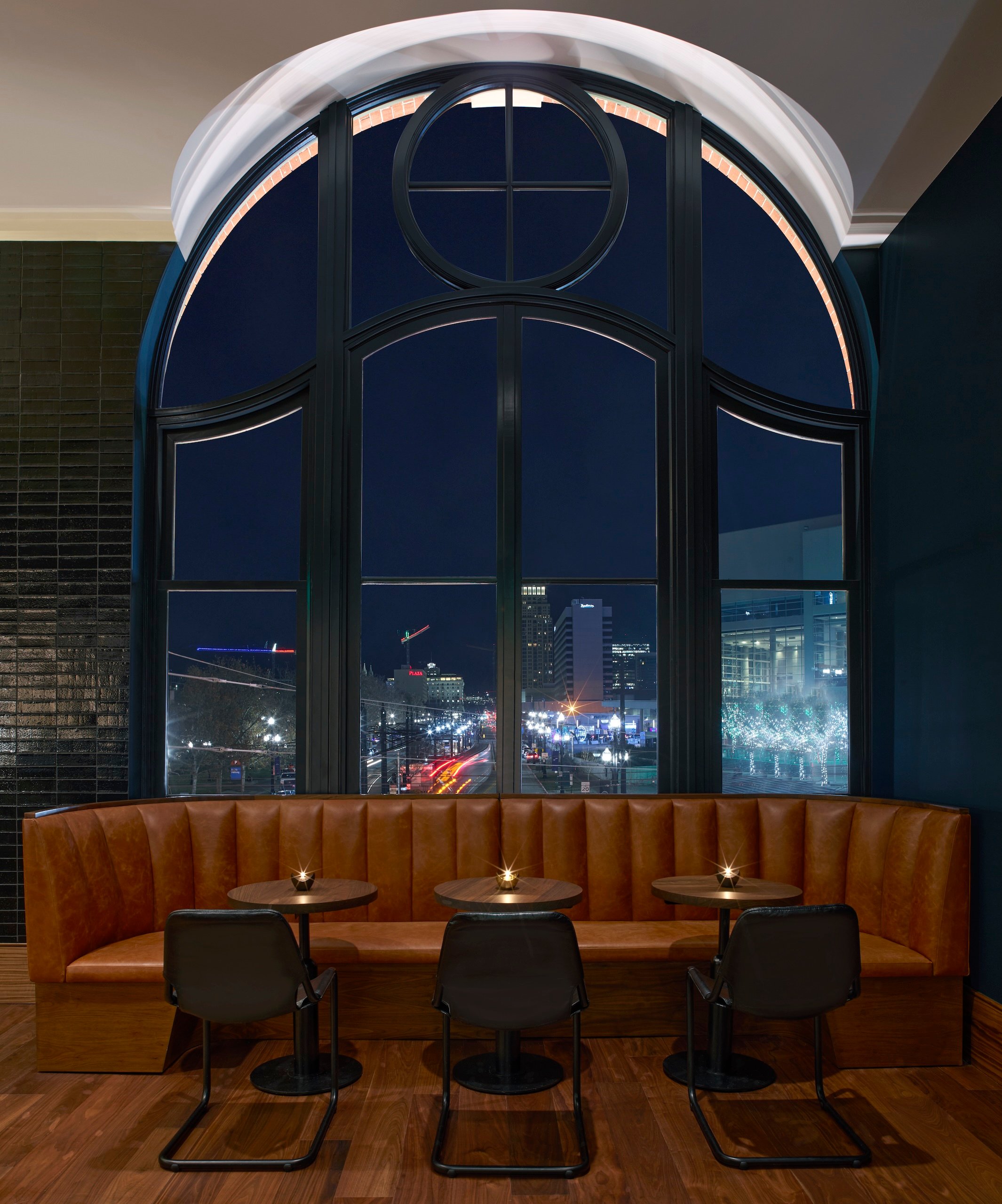 A booth inside No. 119 with views of downtown Salt Lake City lit up at night