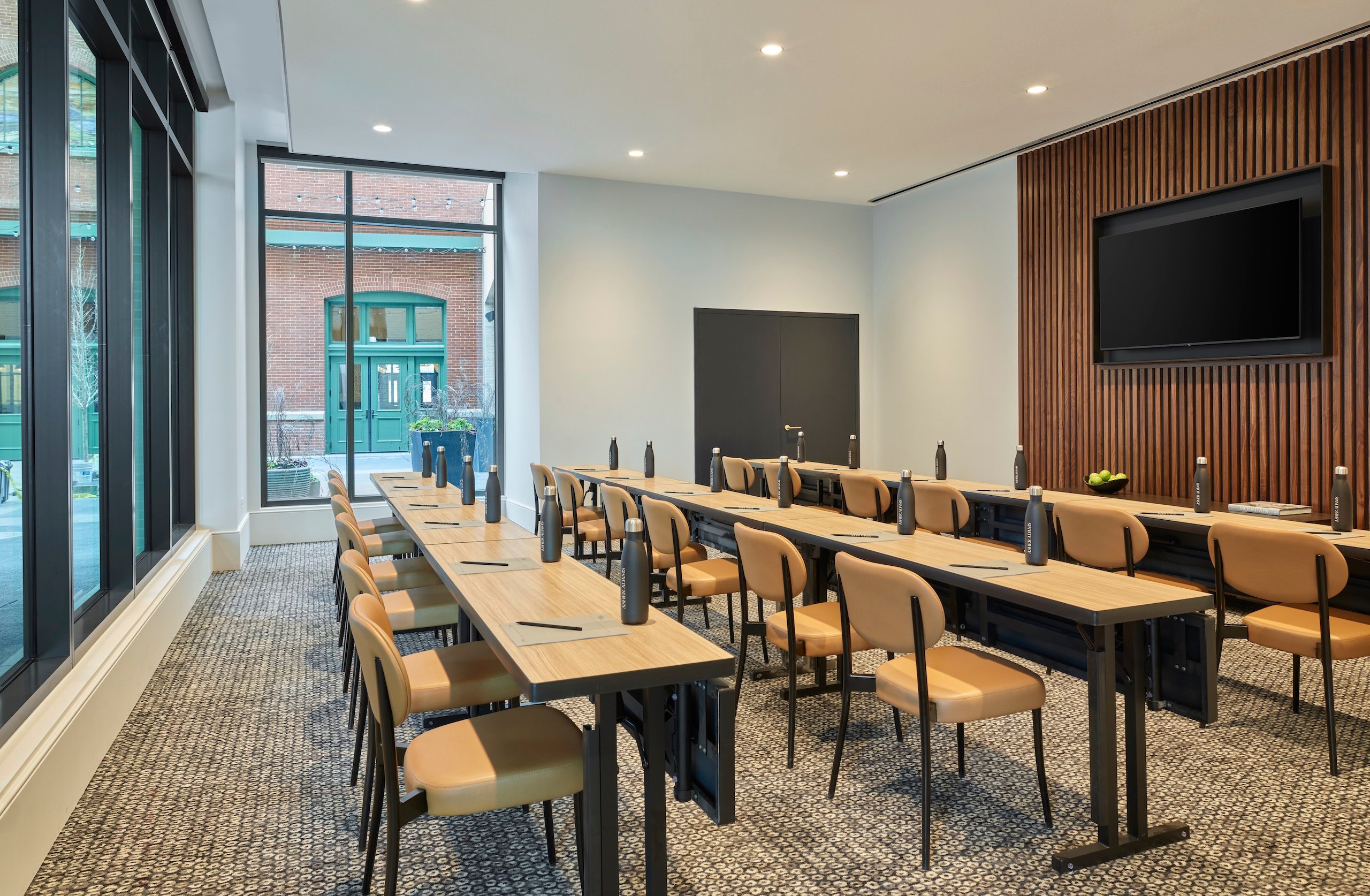 Three long rows of tables and seats in a conference room at Asher Adams Hotel, Salt Lake City