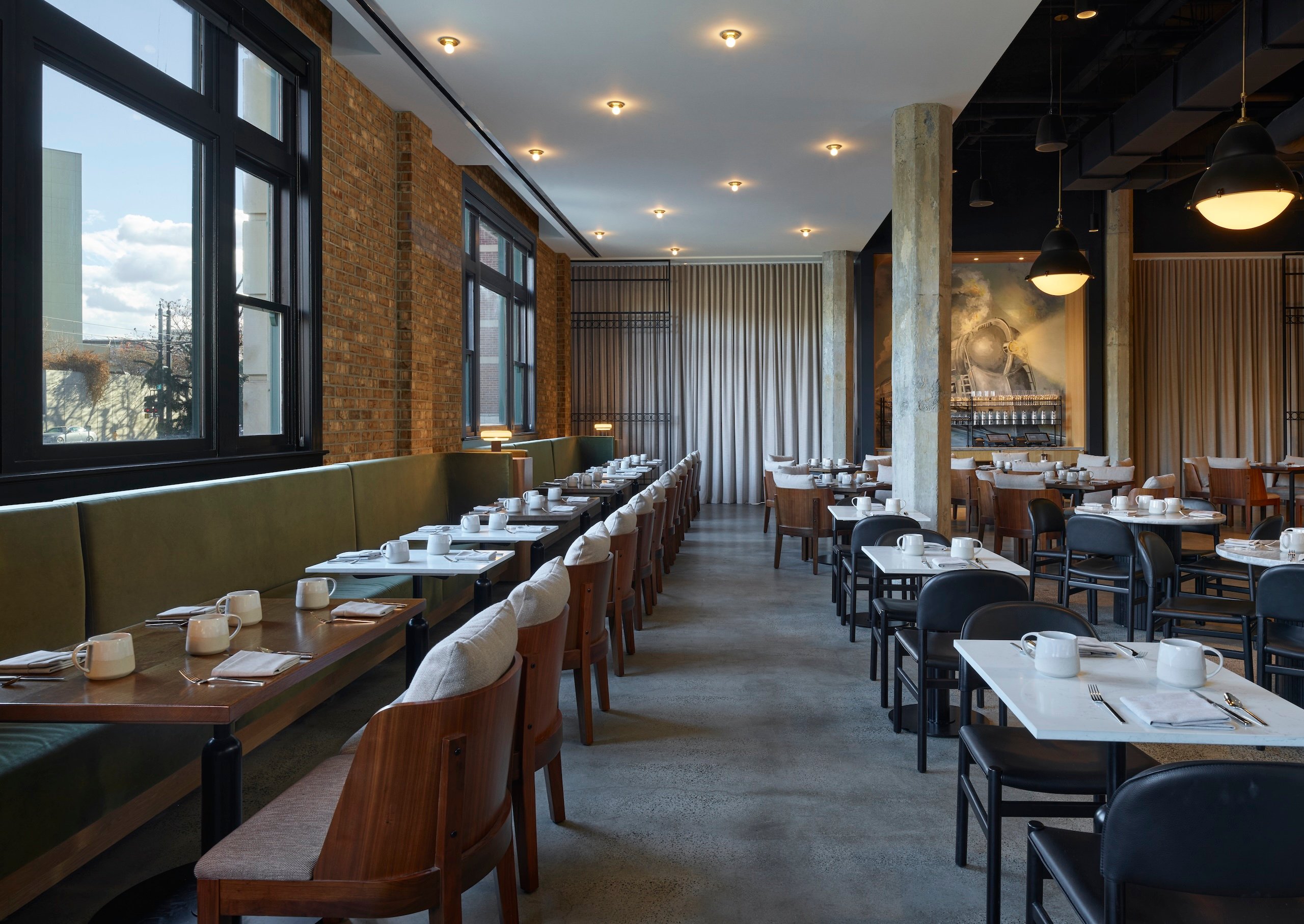 Rows of set dining tables inside Rouser restaurant at Asher Adams Hotel, Salt Lake City